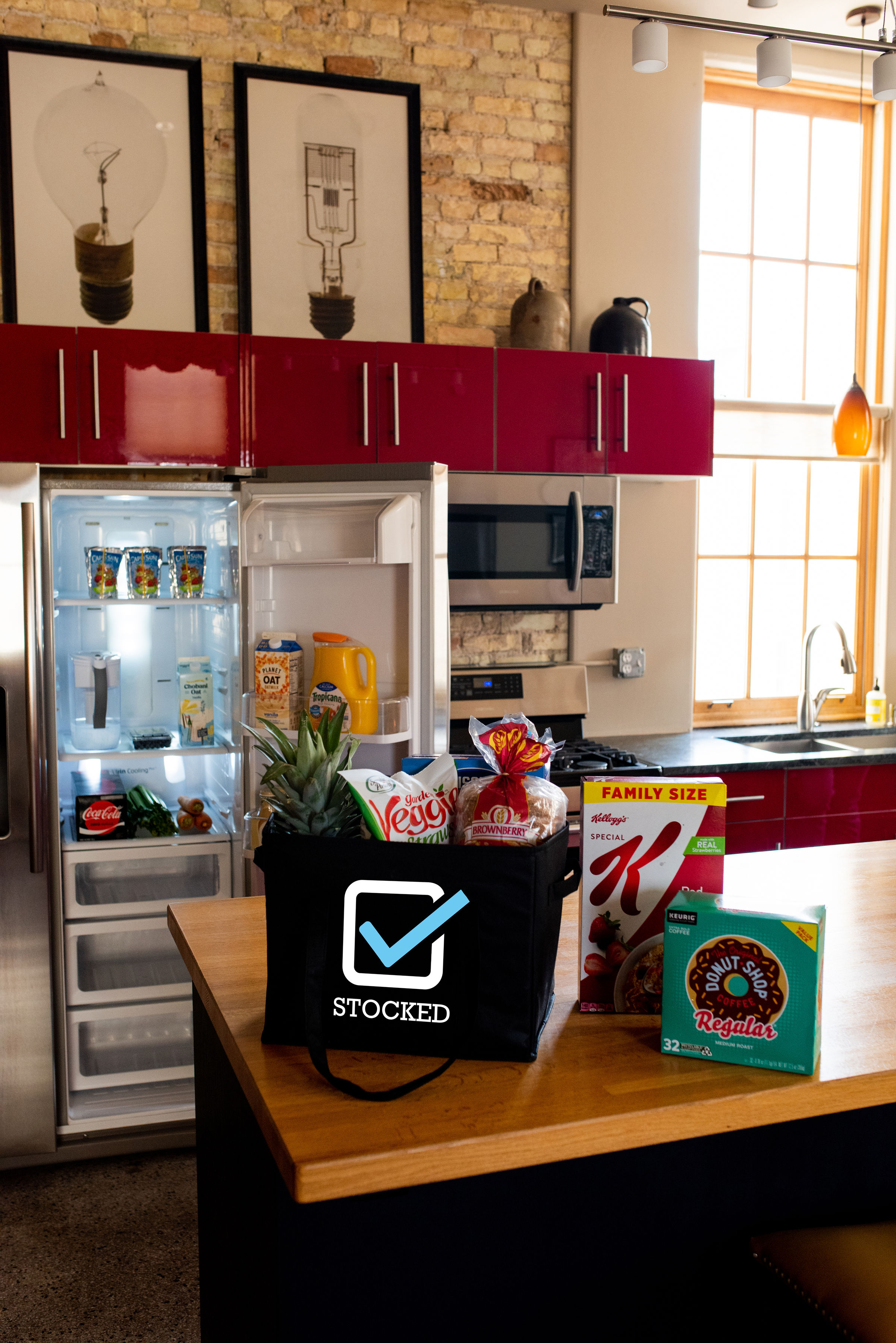 Groceries sitting on the counter and items stocked in the fridge